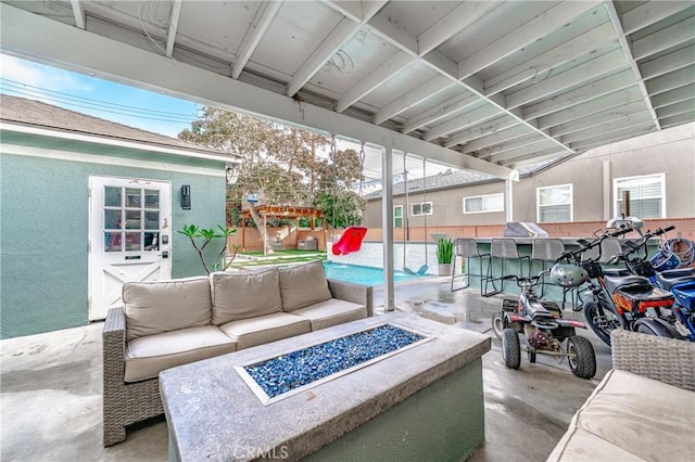 view of patio / terrace with an outdoor living space with a fire pit and an outdoor bar