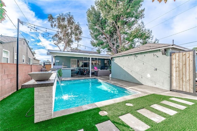 view of swimming pool featuring pool water feature, an outdoor hangout area, a lawn, and a patio