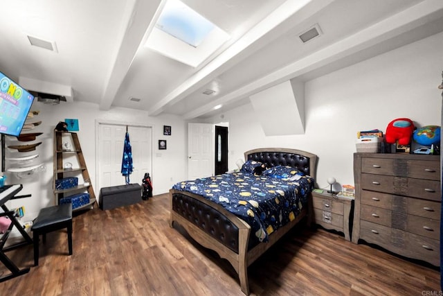 bedroom with dark wood-type flooring and beamed ceiling