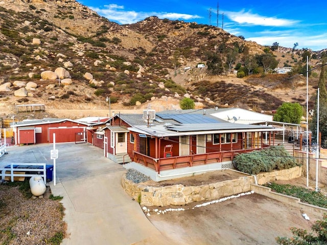 exterior space featuring a mountain view and solar panels