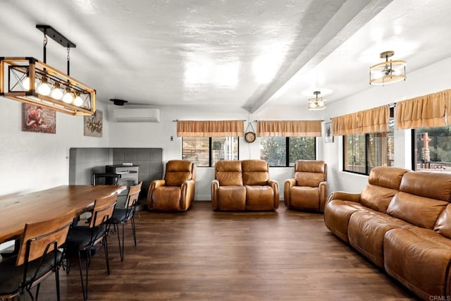 living room with beamed ceiling, dark hardwood / wood-style flooring, and a wall mounted air conditioner