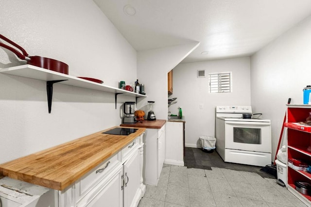 kitchen featuring wooden counters, white cabinetry, and electric range