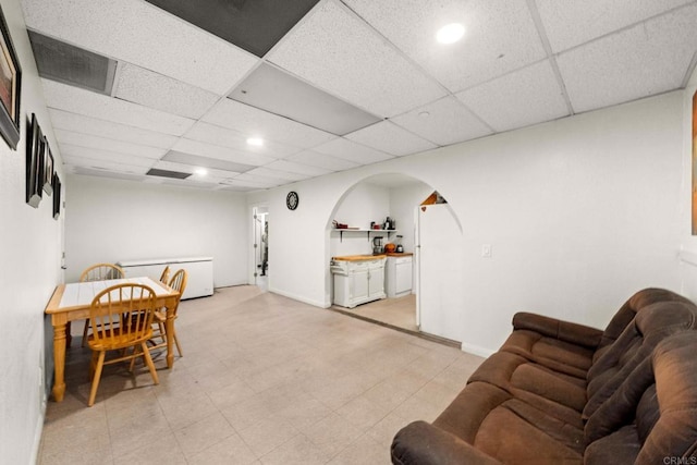 dining area featuring a drop ceiling