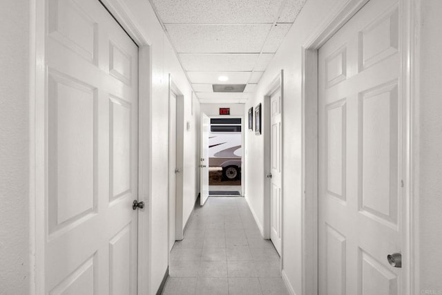 hallway with a drop ceiling