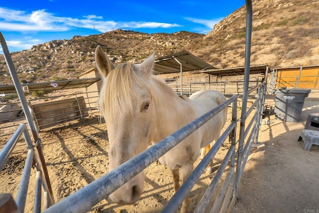 view of stable with a rural view and a mountain view