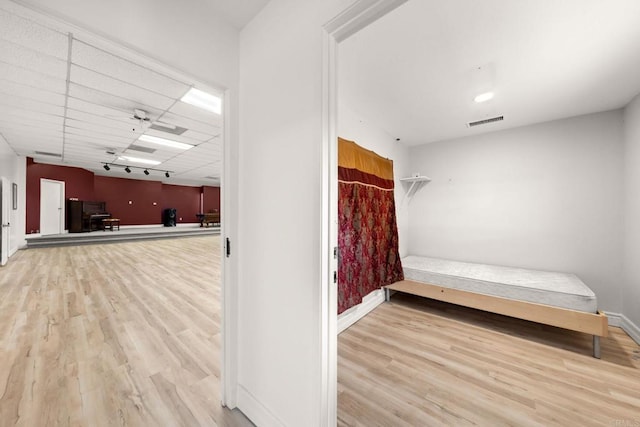 bathroom with a paneled ceiling and hardwood / wood-style flooring