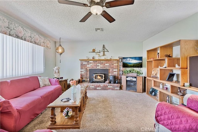 living room with a textured ceiling, ceiling fan, a wood stove, and carpet floors