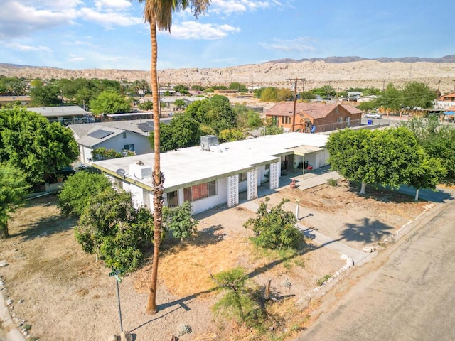 birds eye view of property with a mountain view