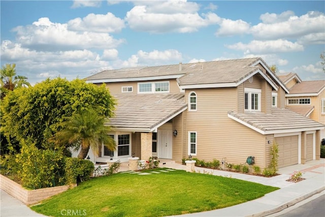 view of front of property with a front lawn and a garage