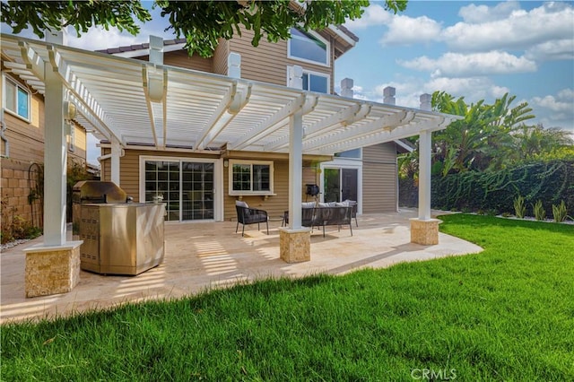 back of house featuring a pergola, a patio, and a yard