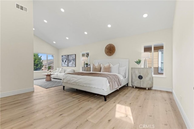 bedroom featuring light wood-type flooring and high vaulted ceiling