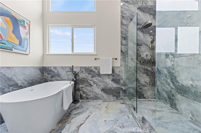 bathroom featuring tile walls and independent shower and bath