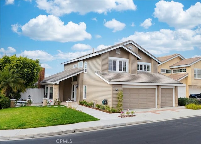 view of front of house featuring a front lawn and a garage