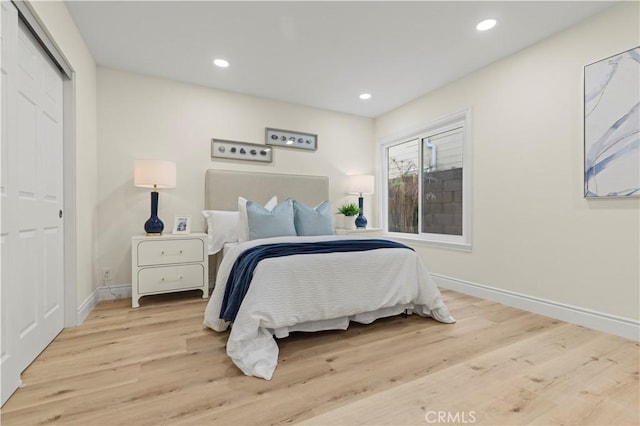 bedroom featuring a closet and light hardwood / wood-style floors