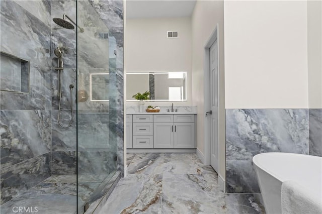 bathroom featuring independent shower and bath, tile walls, and vanity