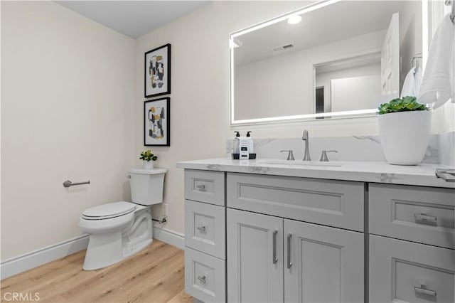 bathroom featuring hardwood / wood-style floors, toilet, and vanity