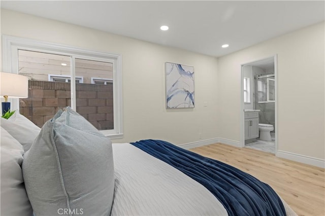 bedroom featuring hardwood / wood-style floors and ensuite bathroom