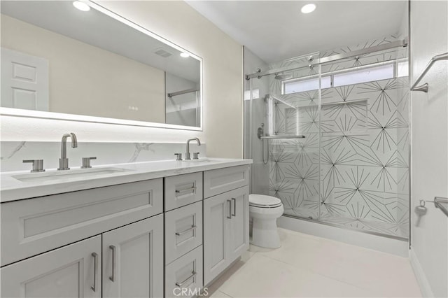 bathroom with toilet, tile patterned flooring, walk in shower, and vanity