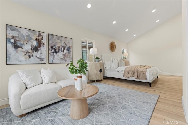 bedroom with vaulted ceiling and hardwood / wood-style floors