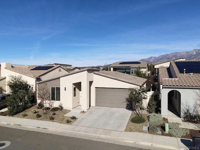 view of front facade with a mountain view and a garage