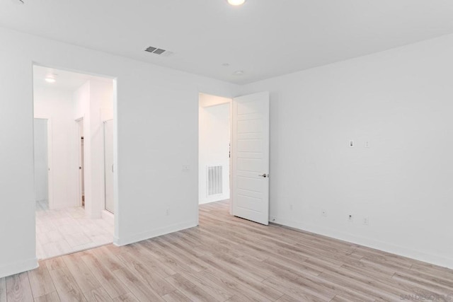 unfurnished room with light wood-type flooring