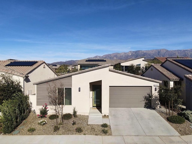 view of front facade with a garage and a mountain view