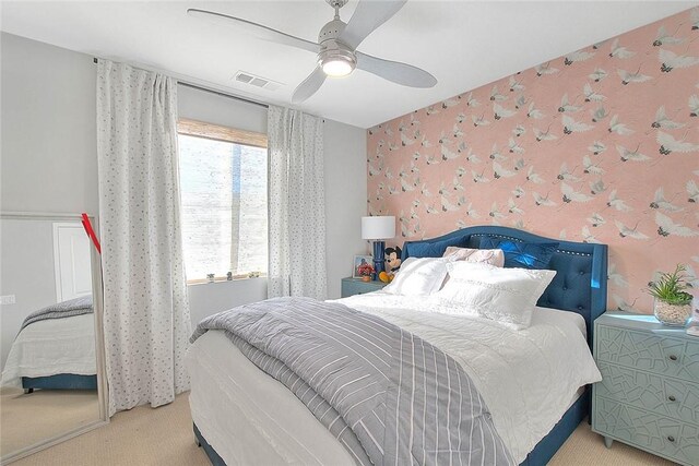 bedroom featuring wallpapered walls, multiple windows, and light colored carpet