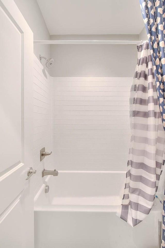 full bath featuring shower / tub combo with curtain