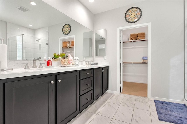 bathroom with a shower with door and vanity