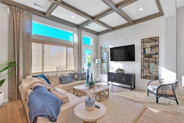 living room featuring light hardwood / wood-style flooring, beam ceiling, and coffered ceiling