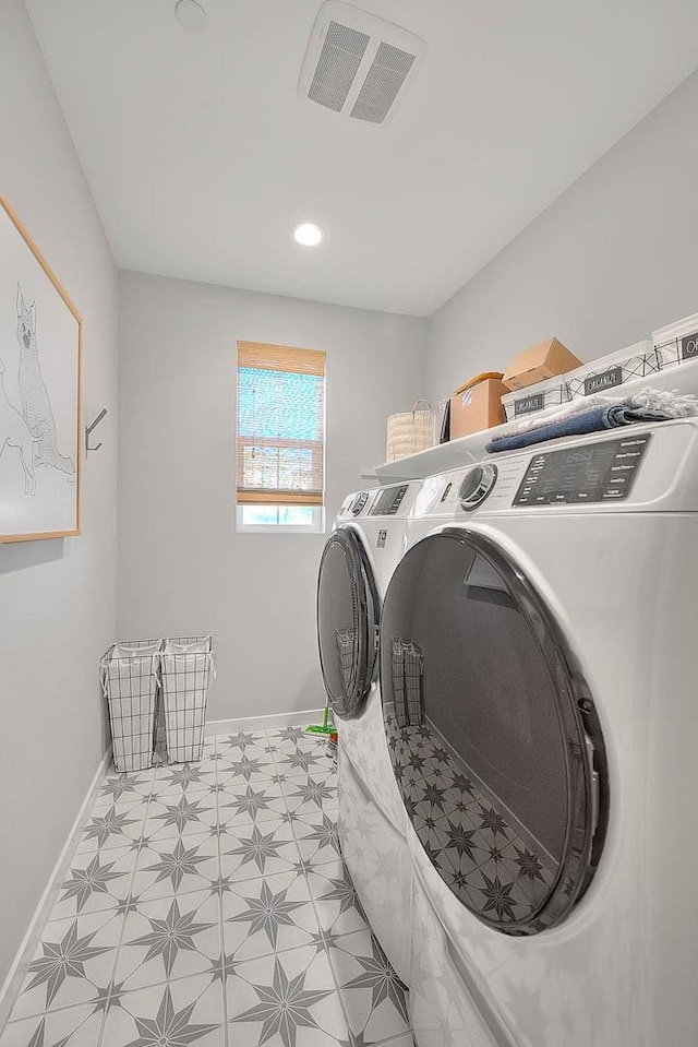 laundry area with washing machine and dryer, laundry area, visible vents, baseboards, and light floors