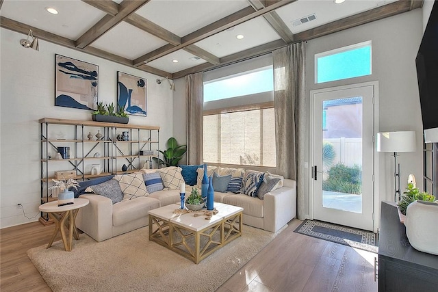 living room with coffered ceiling, hardwood / wood-style flooring, and plenty of natural light