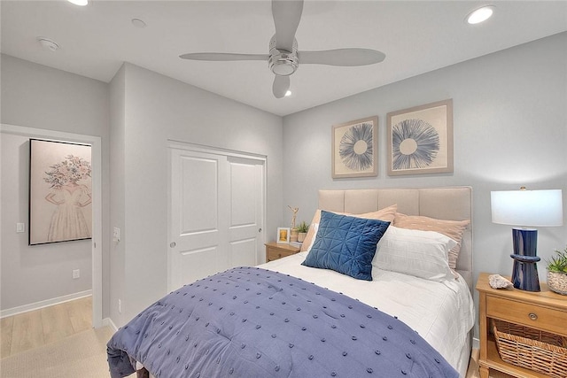 bedroom with recessed lighting, a closet, light wood-style flooring, ceiling fan, and baseboards