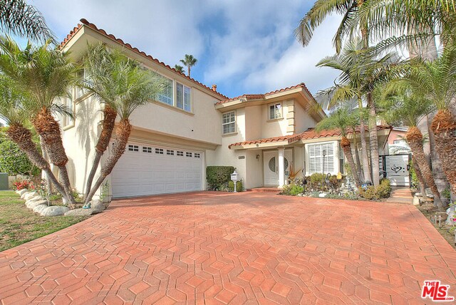 mediterranean / spanish-style house with a garage