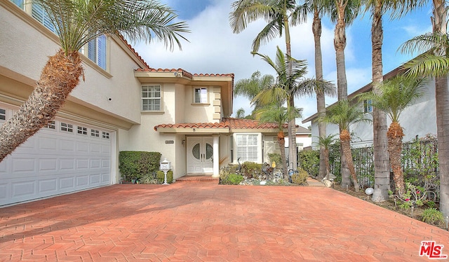 mediterranean / spanish house with a garage