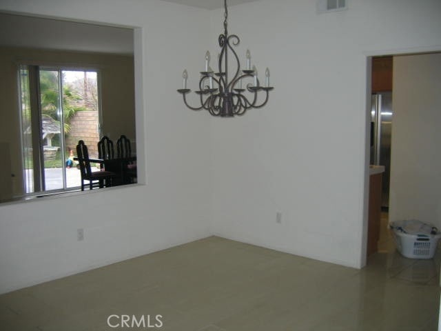 unfurnished dining area with a notable chandelier