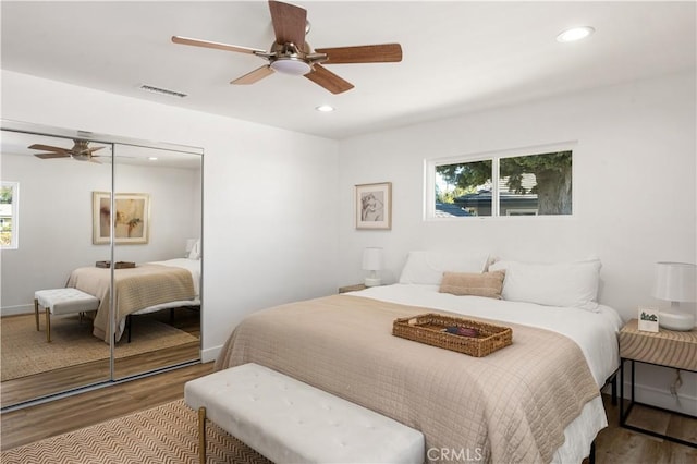 bedroom featuring ceiling fan, a closet, and light hardwood / wood-style flooring