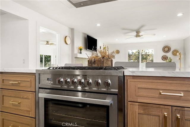 kitchen featuring ceiling fan and stainless steel stove