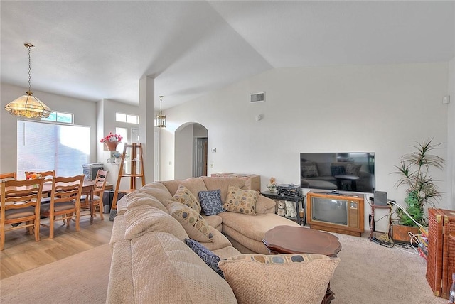 living room with light hardwood / wood-style flooring and vaulted ceiling