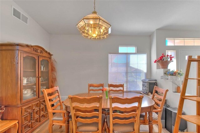 dining room featuring an inviting chandelier and light hardwood / wood-style flooring