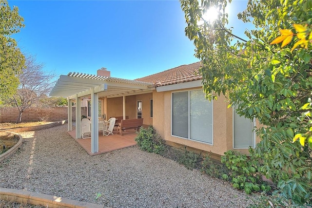 rear view of house with a pergola and a patio area