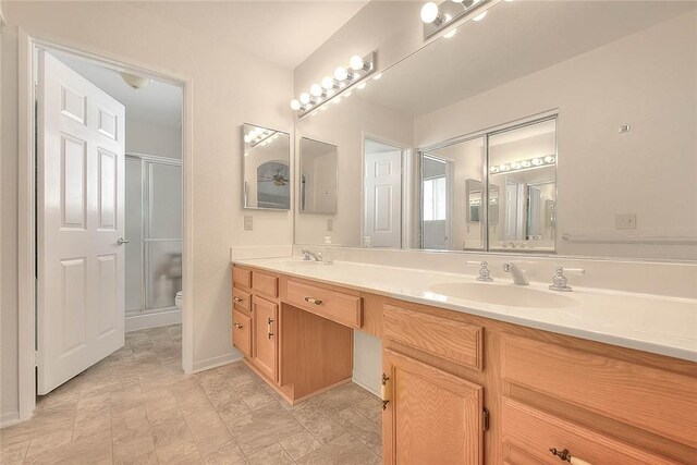 bathroom featuring vanity, toilet, and walk in shower