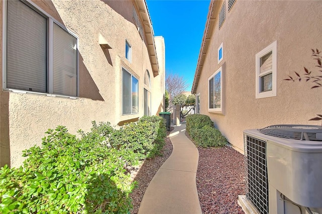 view of side of home with central AC