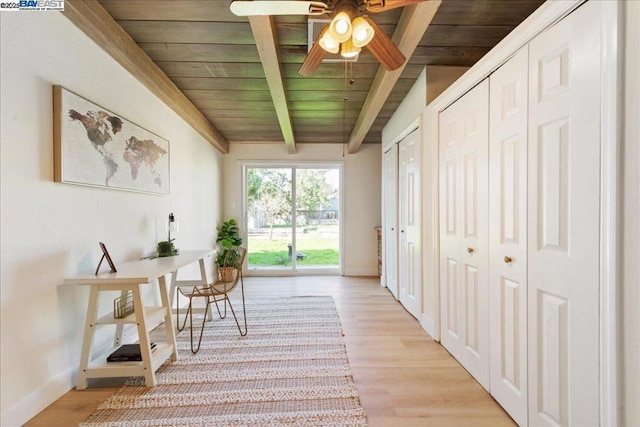 interior space featuring wooden ceiling, light hardwood / wood-style flooring, and lofted ceiling with beams