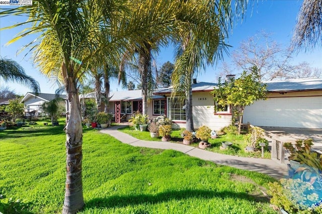 single story home featuring a front lawn and a garage