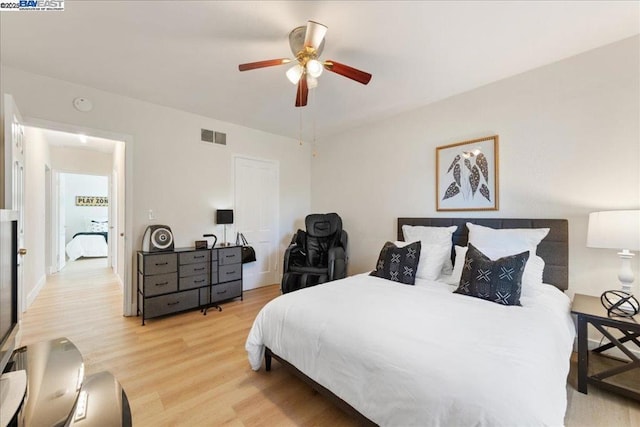 bedroom with ceiling fan and light hardwood / wood-style floors