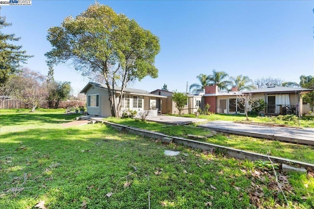 single story home with a front lawn and a patio