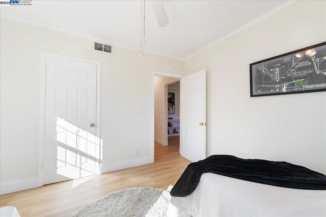 bedroom with ceiling fan, light hardwood / wood-style flooring, and ornamental molding