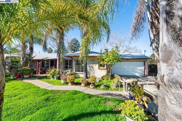 ranch-style house featuring a front lawn and a garage