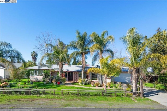 ranch-style house featuring a front lawn and a garage